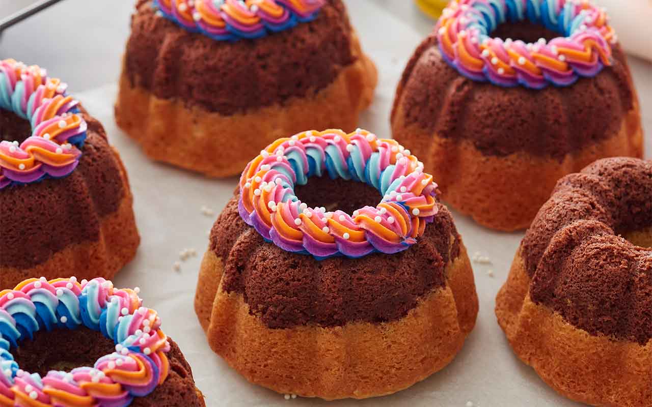 mini fluted cakes with colorful frosting