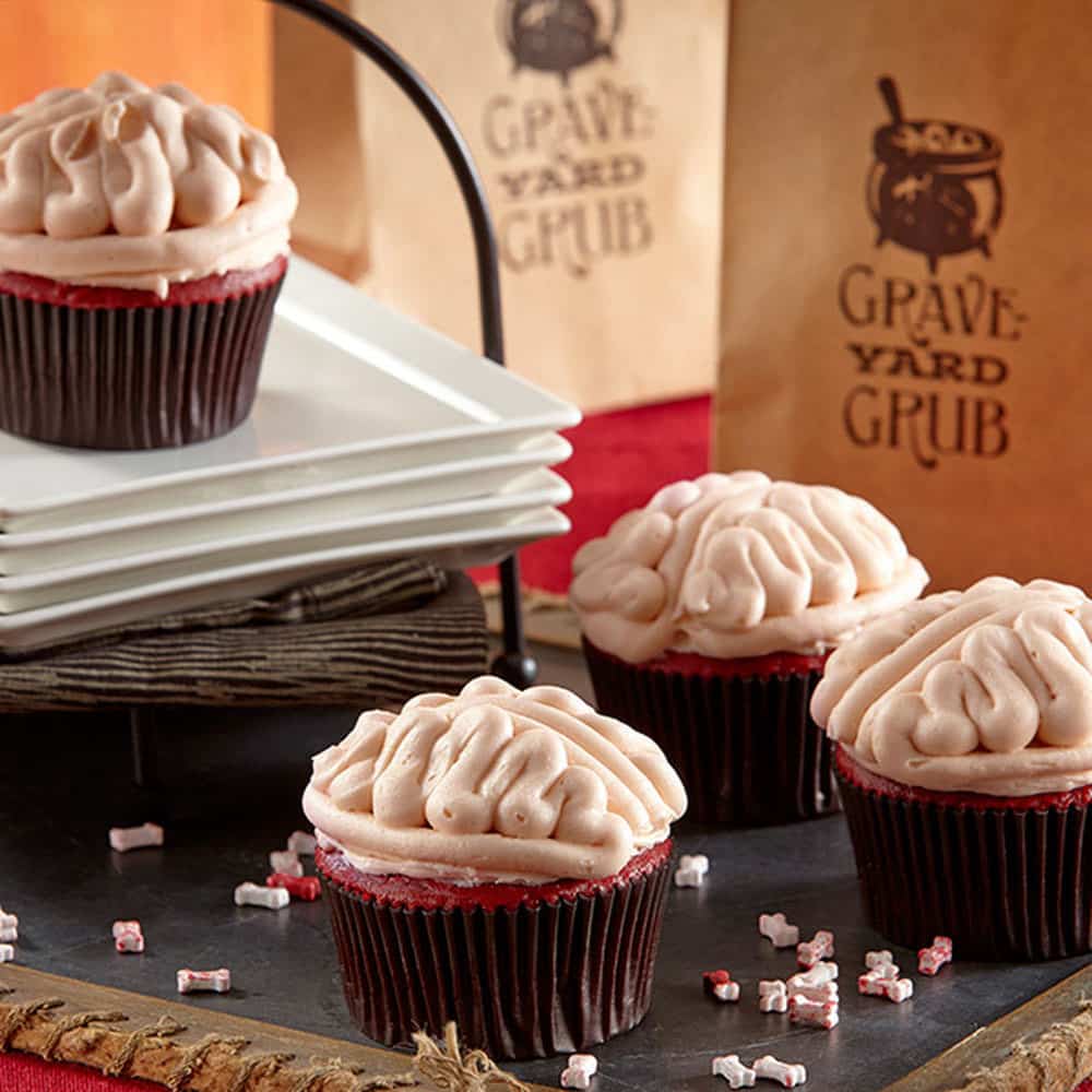 red cupcakes with buttercream brain decorations