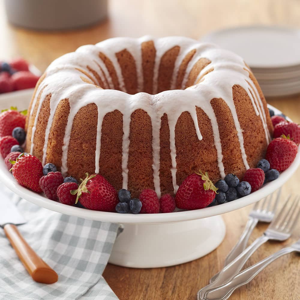 classic pound cake with icing and berries