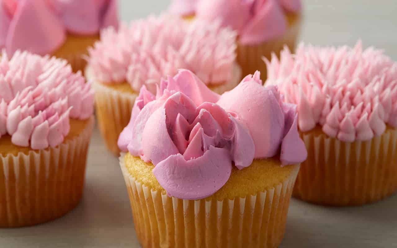 https://blog.wilton.com/wp-content/uploads/sites/2/2019/10/easy-blooms-pink-floral-cupcakes.jpg