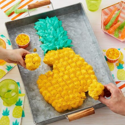 people grabbing from a pineapple pull apart cake