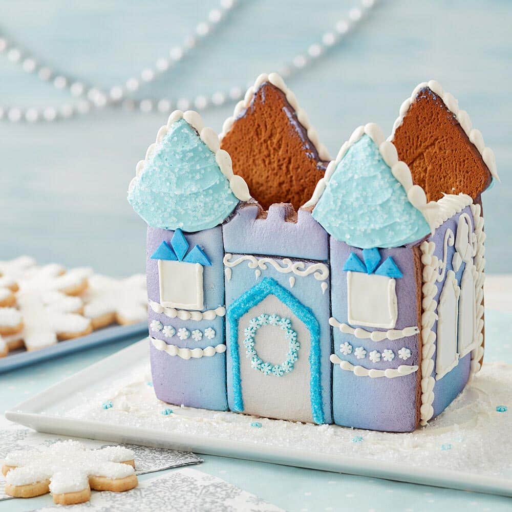 Winter princess castle with blue and purple ombre on the walls, blue icing roof and white icing details