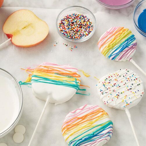 Candy-covered apple slices on a lollipop stick