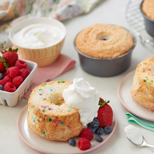 Mini angel food cakes with whipped cream and berries