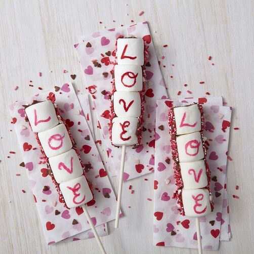 Valentine's Day "L-O-V-E" marshmallow pops with red and pink sprinkles