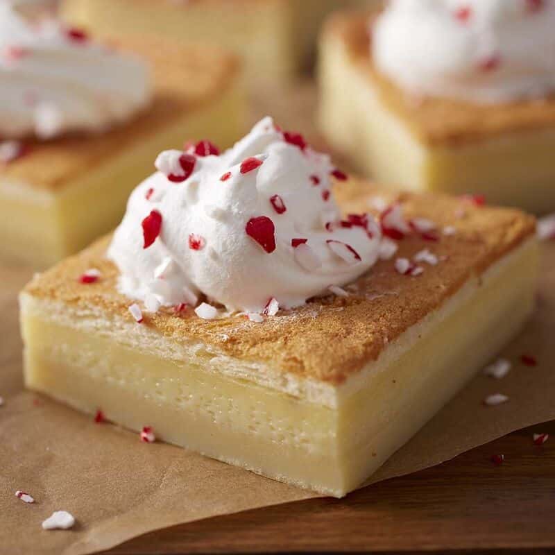 White chocolate peppermint magic cake topped with peppermint sprinkles