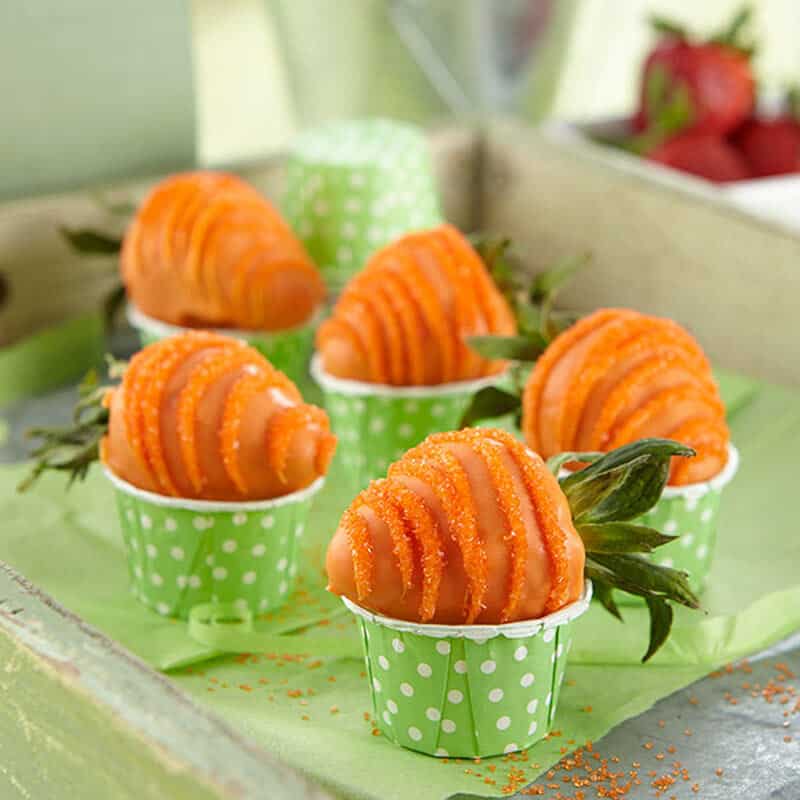 Orange candy-coated strawberries to look like carrots