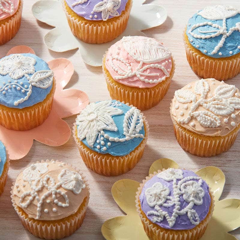 Spring cupcakes with piped flowers that look like embroidery