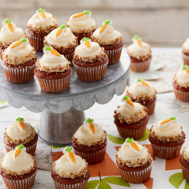 Mini carrot cake cupcakes topped with min edible carrot decoration