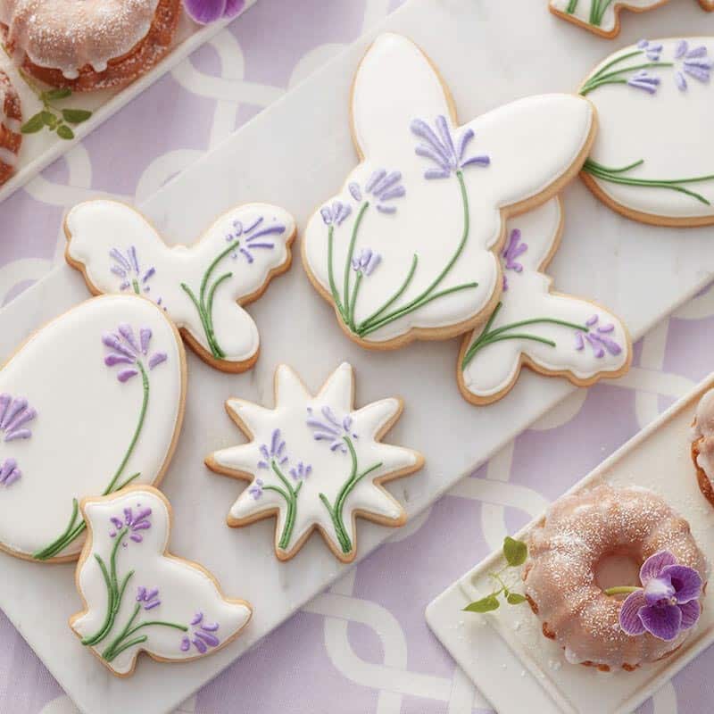 cookies shaped like flowers, butterflies, bunnies and eggs and decorated with blooming flowers