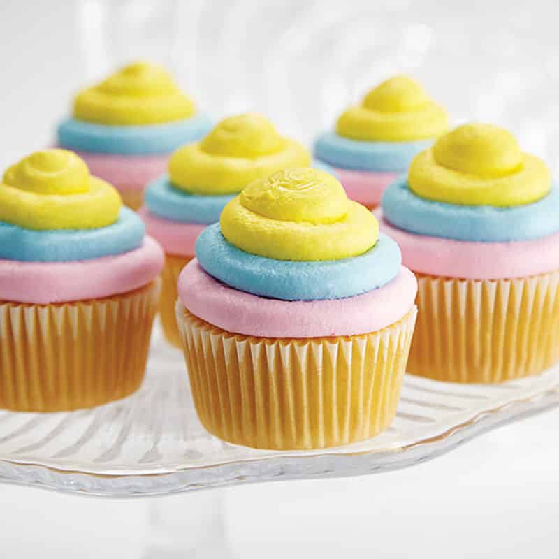 cupcakes decorated with pastel colored buttercream frosting