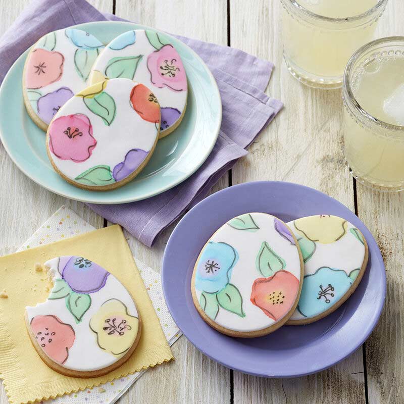 egg shaped cookies decorated with flowers made of fondant