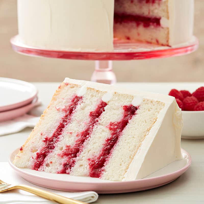 white buttercream frosted cake with raspberry filling