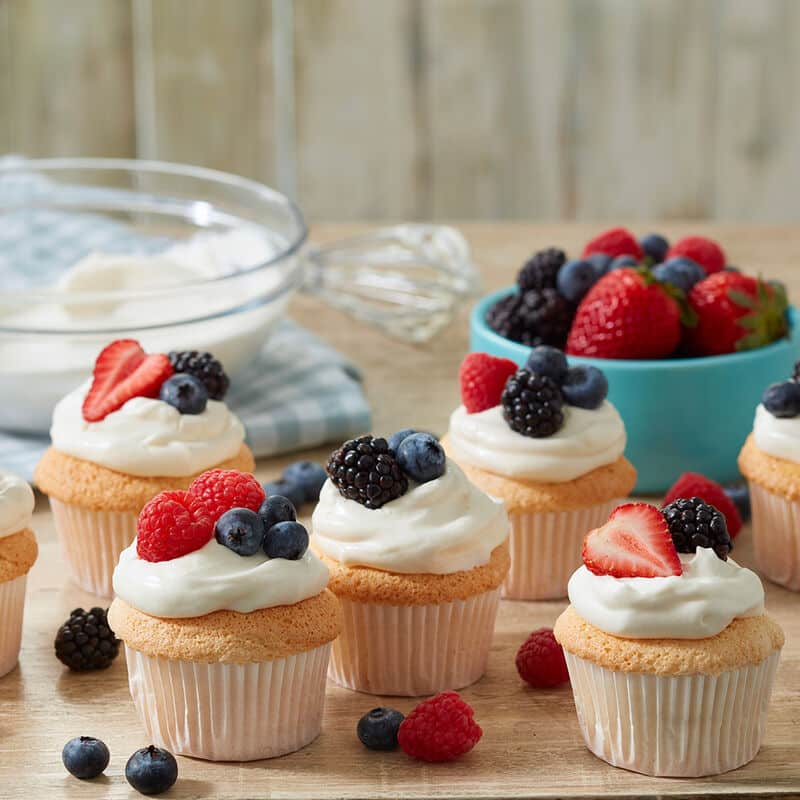 angel food cupcakes topped with fresh mixed berries