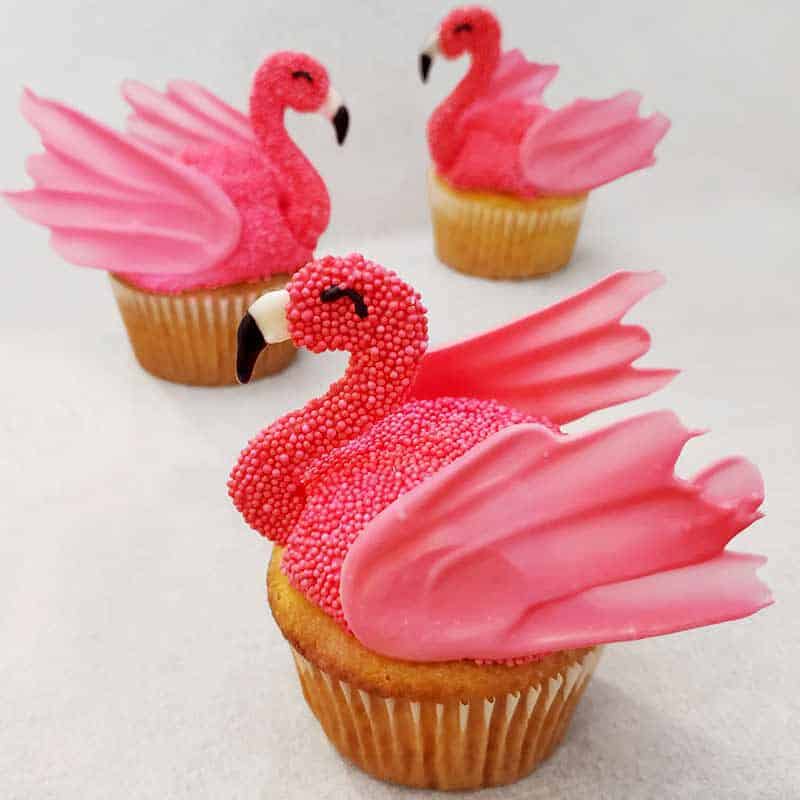 vanilla cupcakes, topped with flamingos made with pink candy melts candy