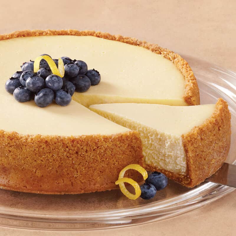 lemon cheesecake topped with blueberries and lemons