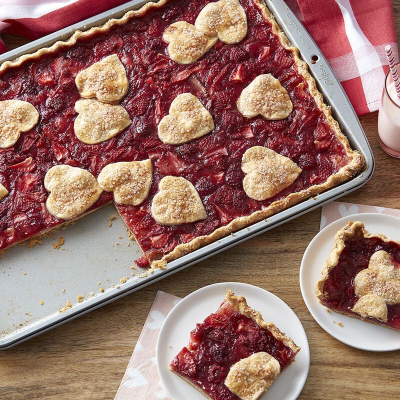 strawberry rhubarb slab pie topped with heart shaped crust