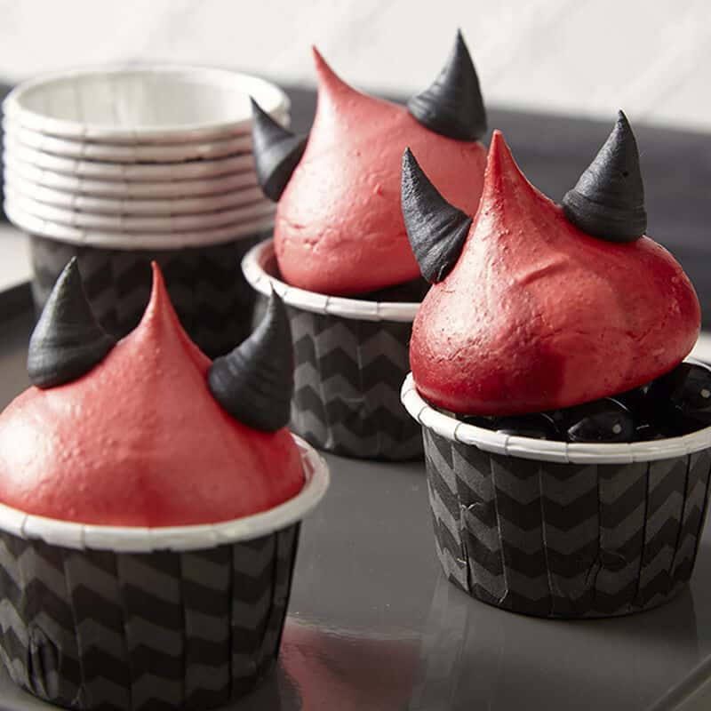 Red meringue cookies with little black devil horns