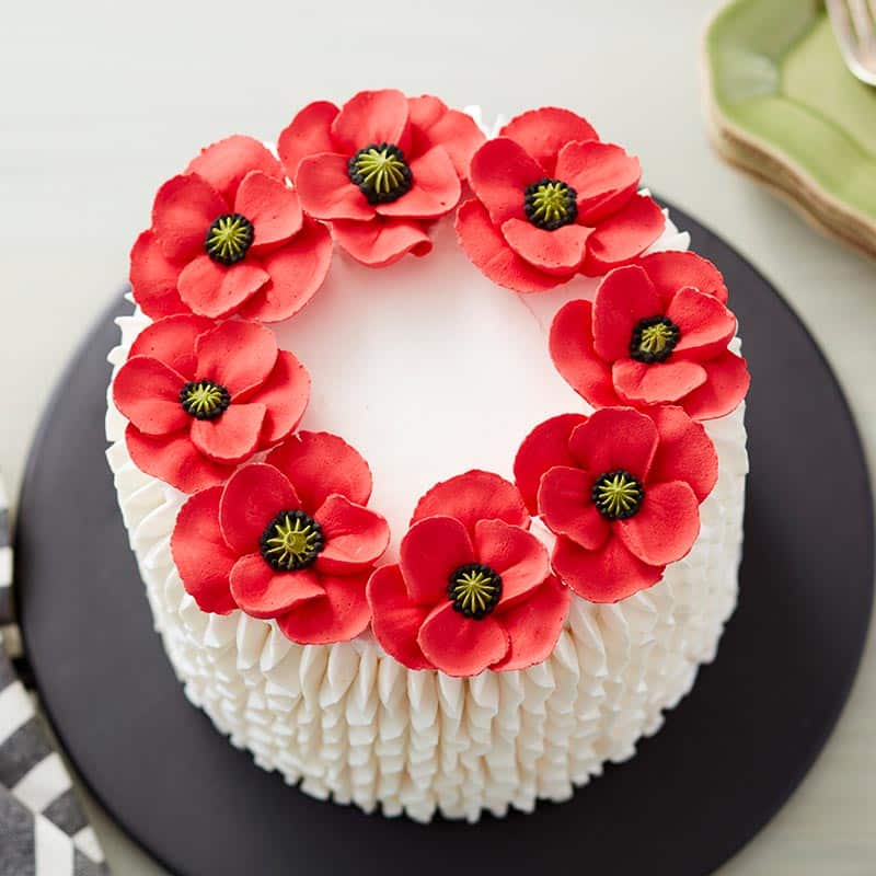 White cake with red poppies