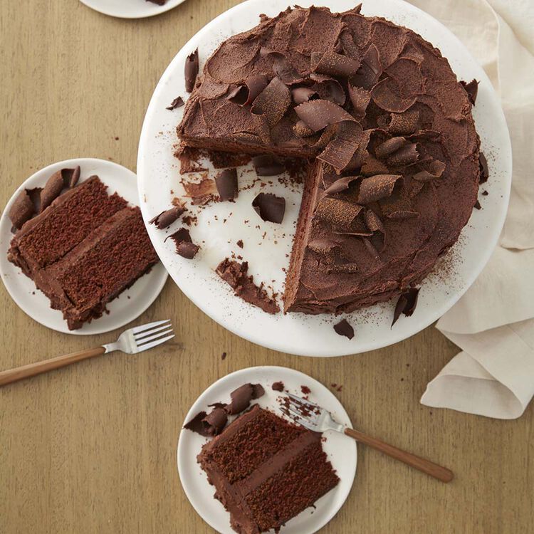 chocolate buttercream being spread on chocolate cake