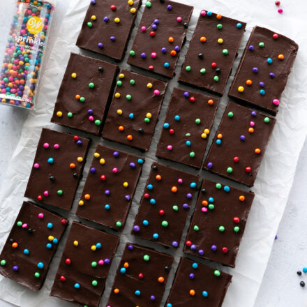 Rainbow chip brownies on parchment paper with Wilton Rainbow Chips